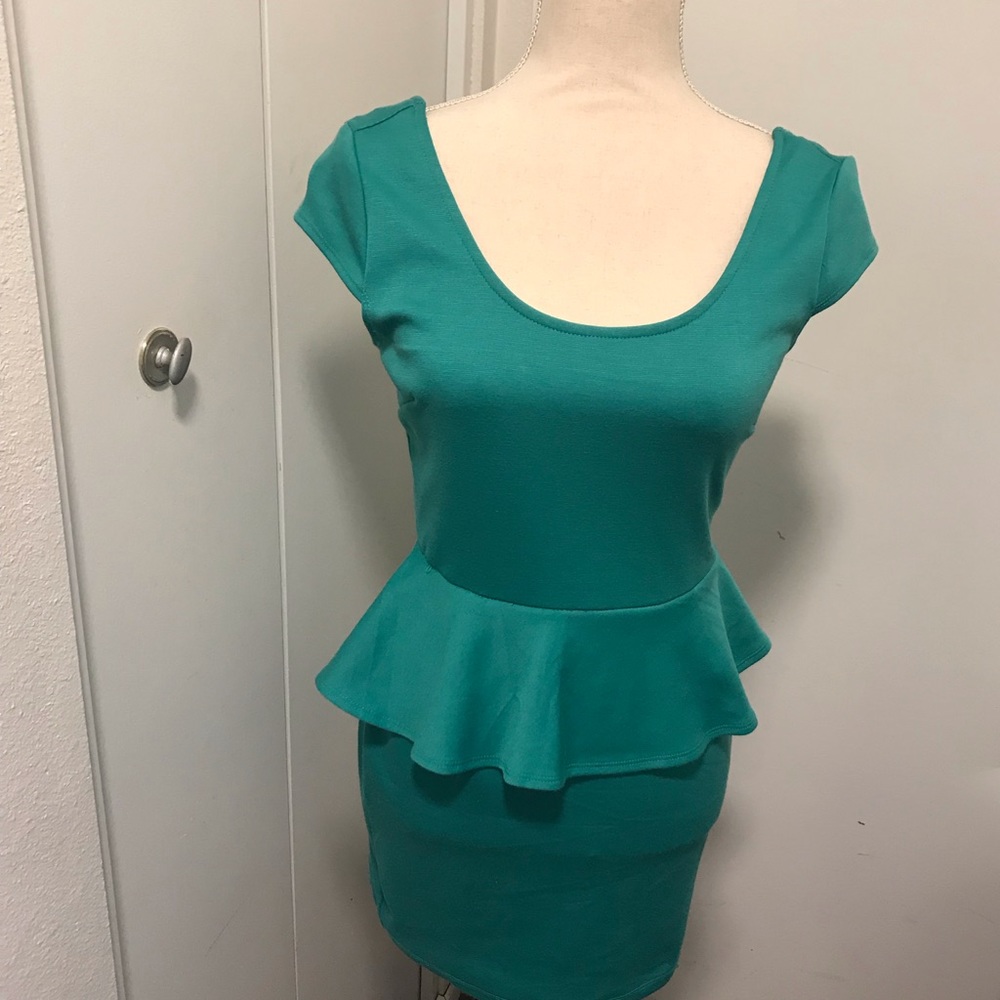 Turquoise Peplum dress with capped sleeves.